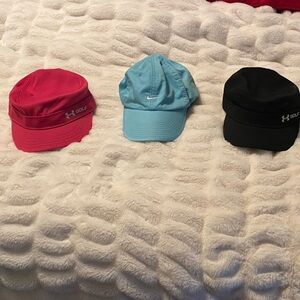 3 Women’s adjustable Golf hats- pink & black UA cadet style, blue Nike.